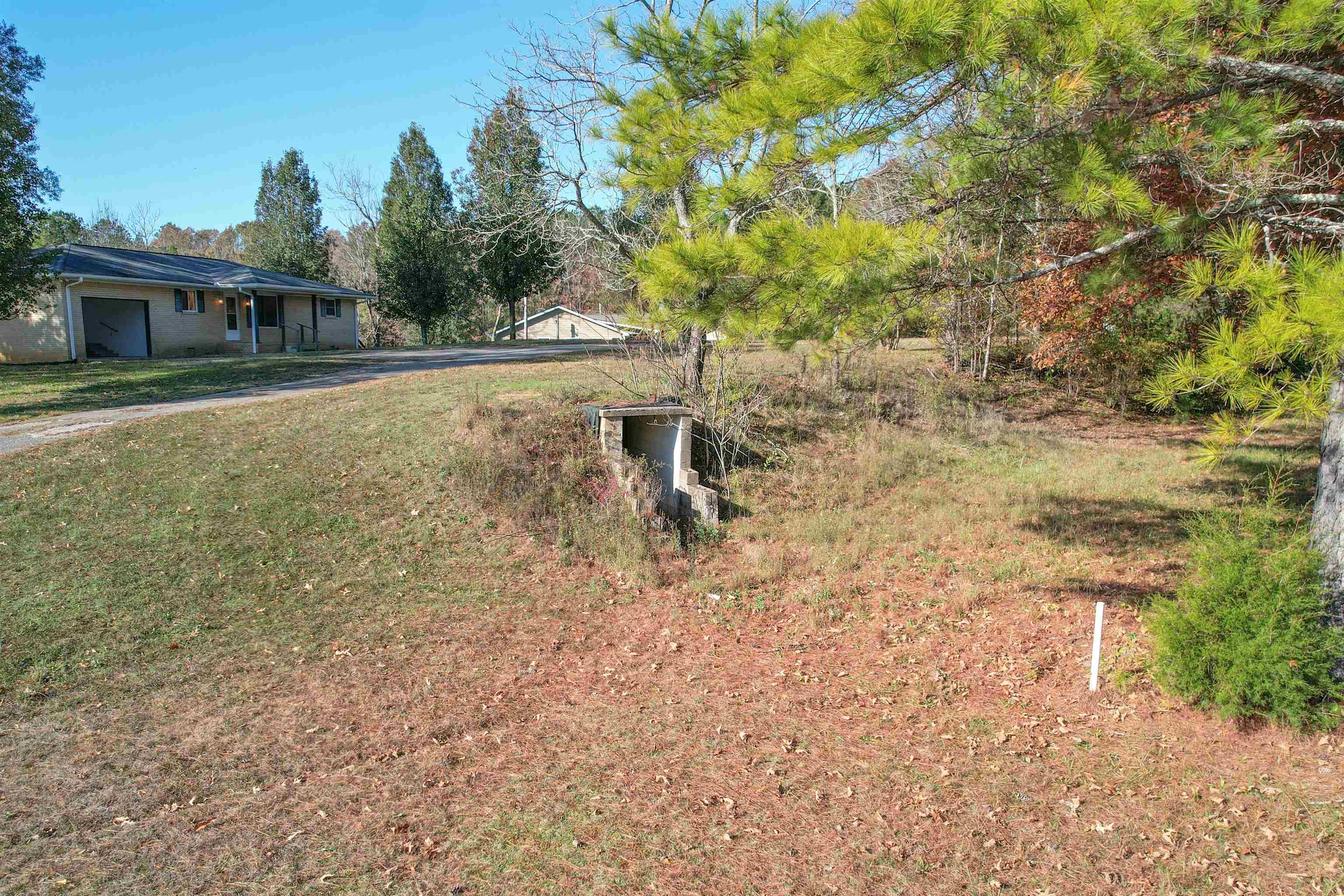 1070 Pine Top Road Toone, TN 38381 - Photo 28 of 30 a backyard of a house with table and chairs