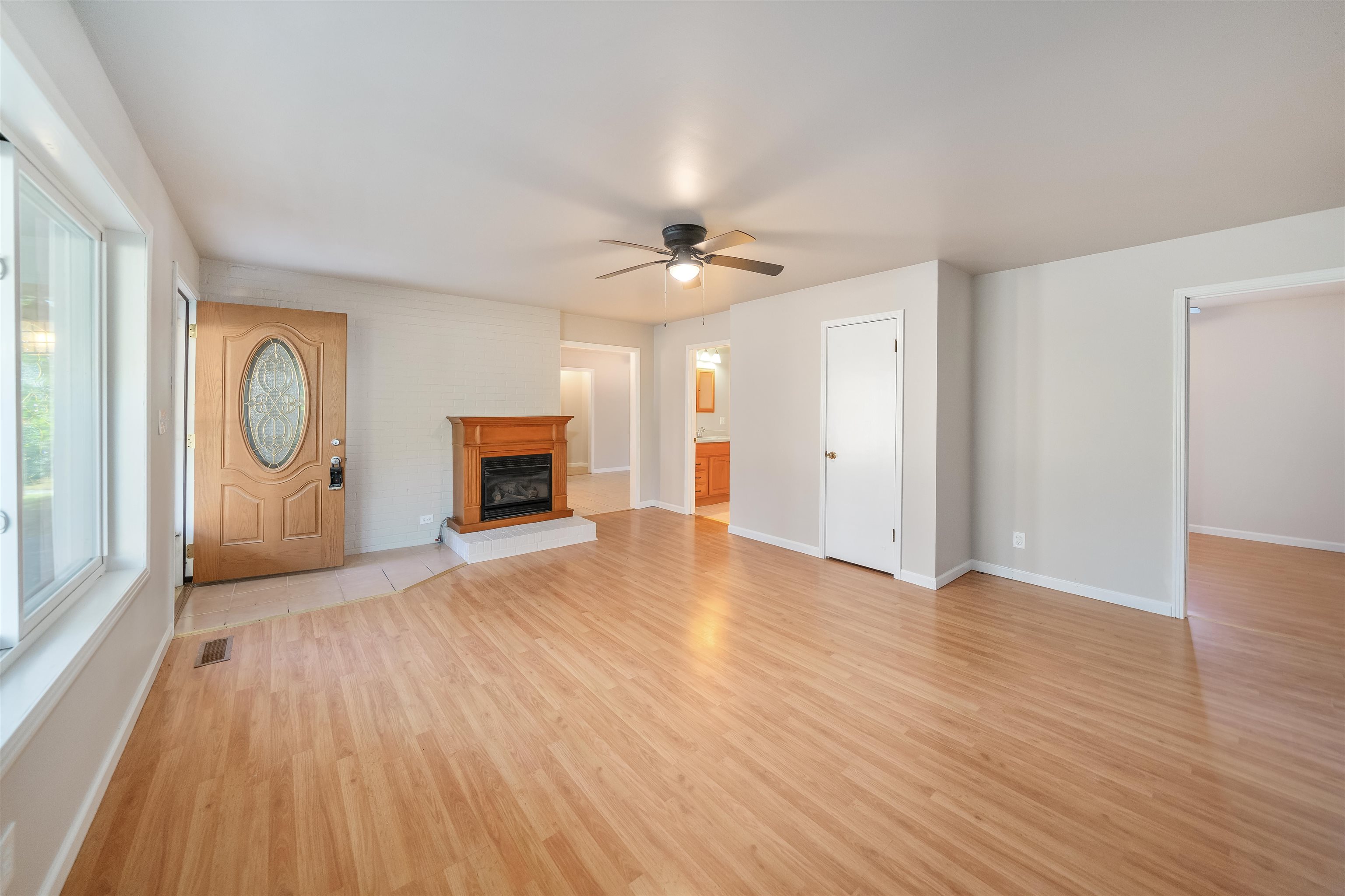 1070 Pine Top Road Toone, TN 38381 - Photo 3 of 30 an empty room with wooden floor and windows