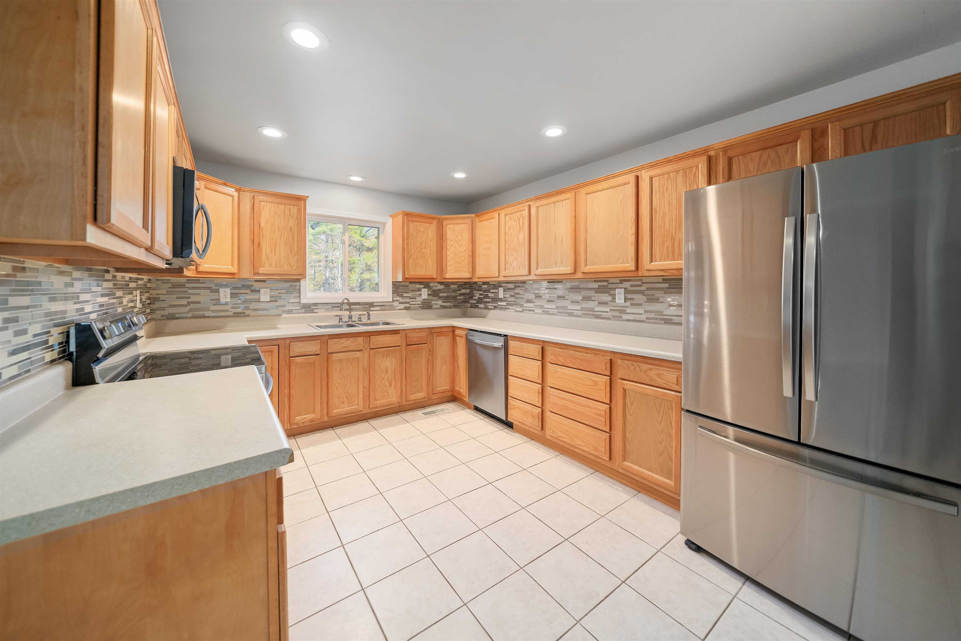 1070 Pine Top Road Toone, TN 38381 - Photo 5 of 30 a kitchen with stainless steel appliances granite countertop a refrigerator sink and white cabinets