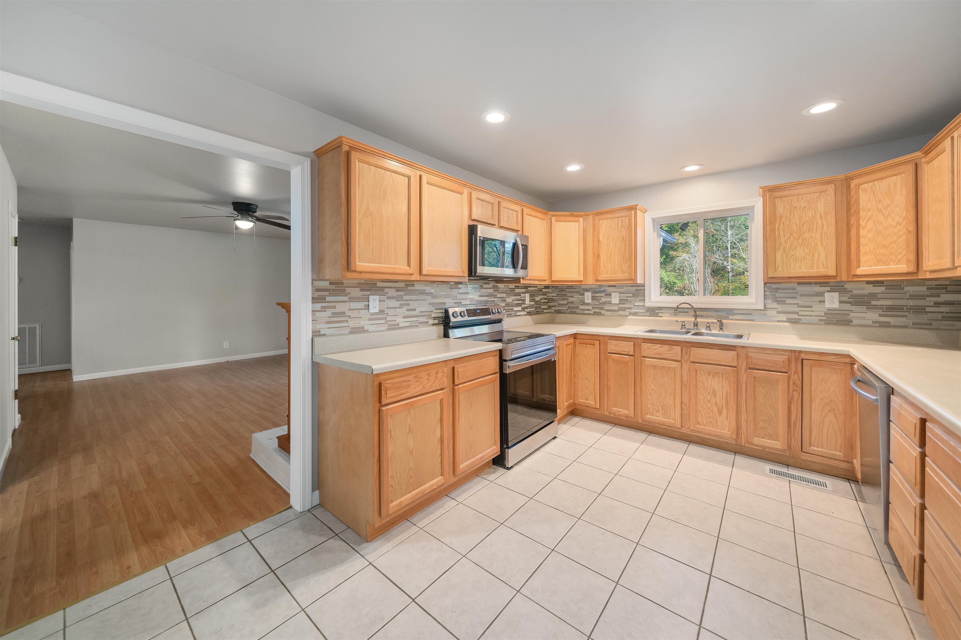 1070 Pine Top Road Toone, TN 38381 - Photo 6 of 30 a kitchen with a sink window and cabinets