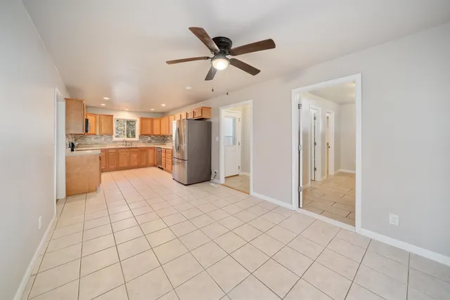 a view of a kitchen with a sink and a refrigerator