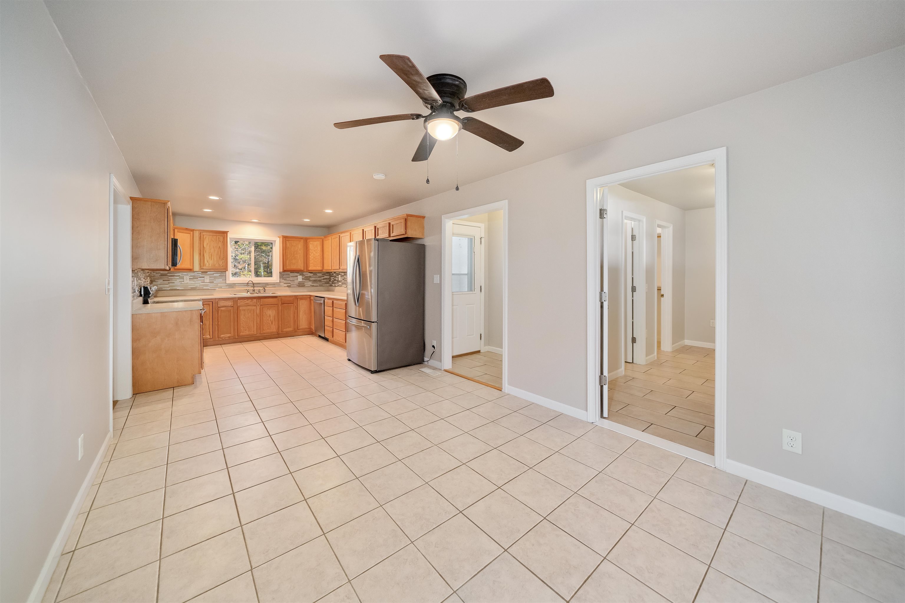 1070 Pine Top Road Toone, TN 38381 - Photo 7 of 30 a view of a kitchen with a sink and a refrigerator