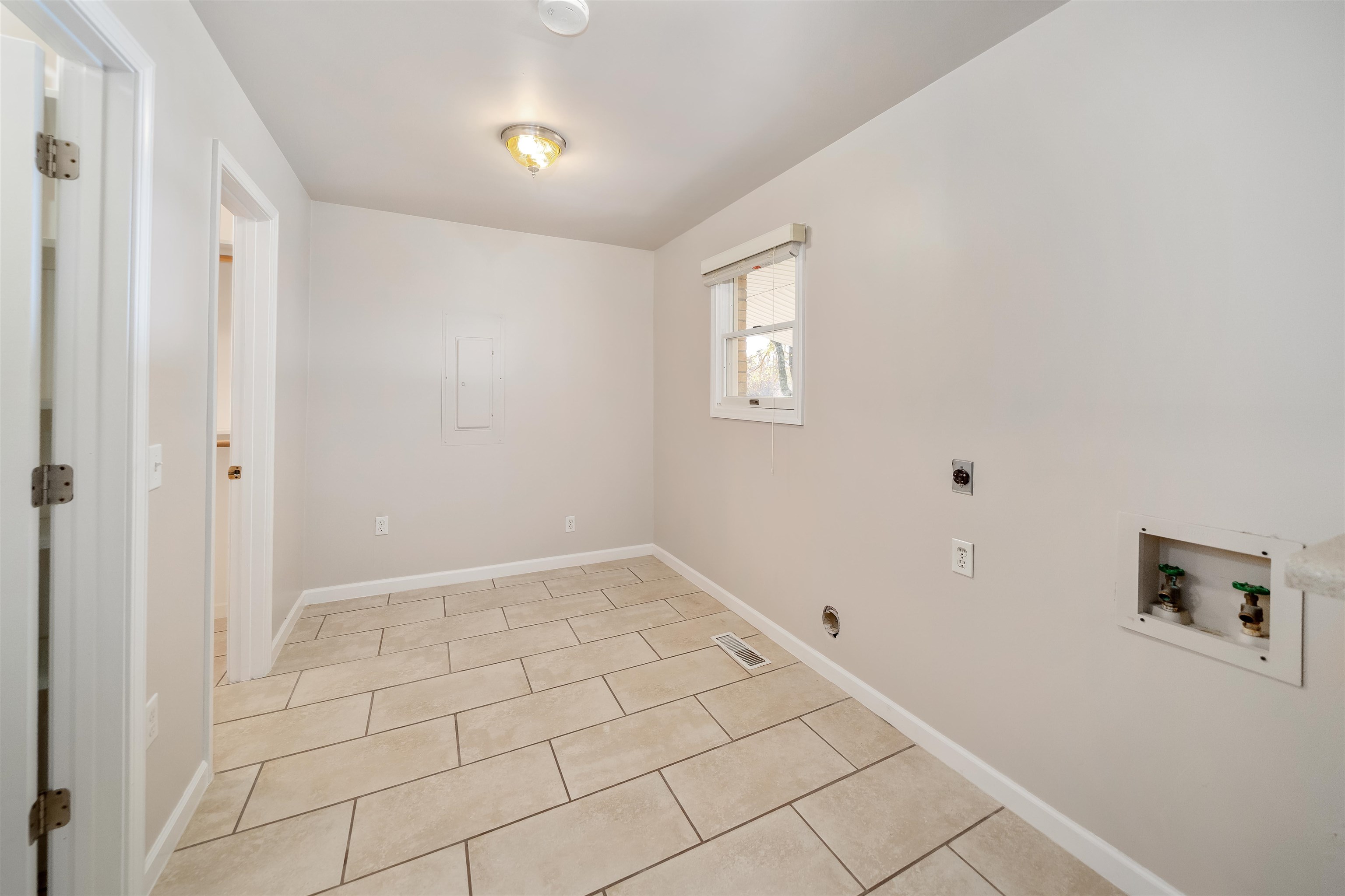 1070 Pine Top Road Toone, TN 38381 - Photo 9 of 30 a view of an empty room with window and chandelier fan