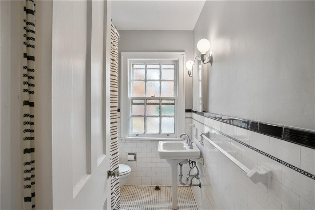420 Sulgrave Road Pittsburgh, PA 15211 - Photo 18 of 35 a spacious bathroom with a granite countertop sink a mirror and shower