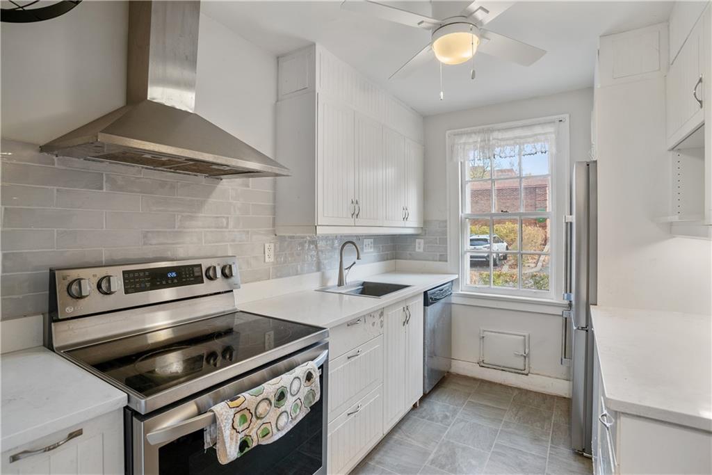 420 Sulgrave Road Pittsburgh, PA 15211 - Photo 7 of 35 a kitchen with a stove a sink and a microwave