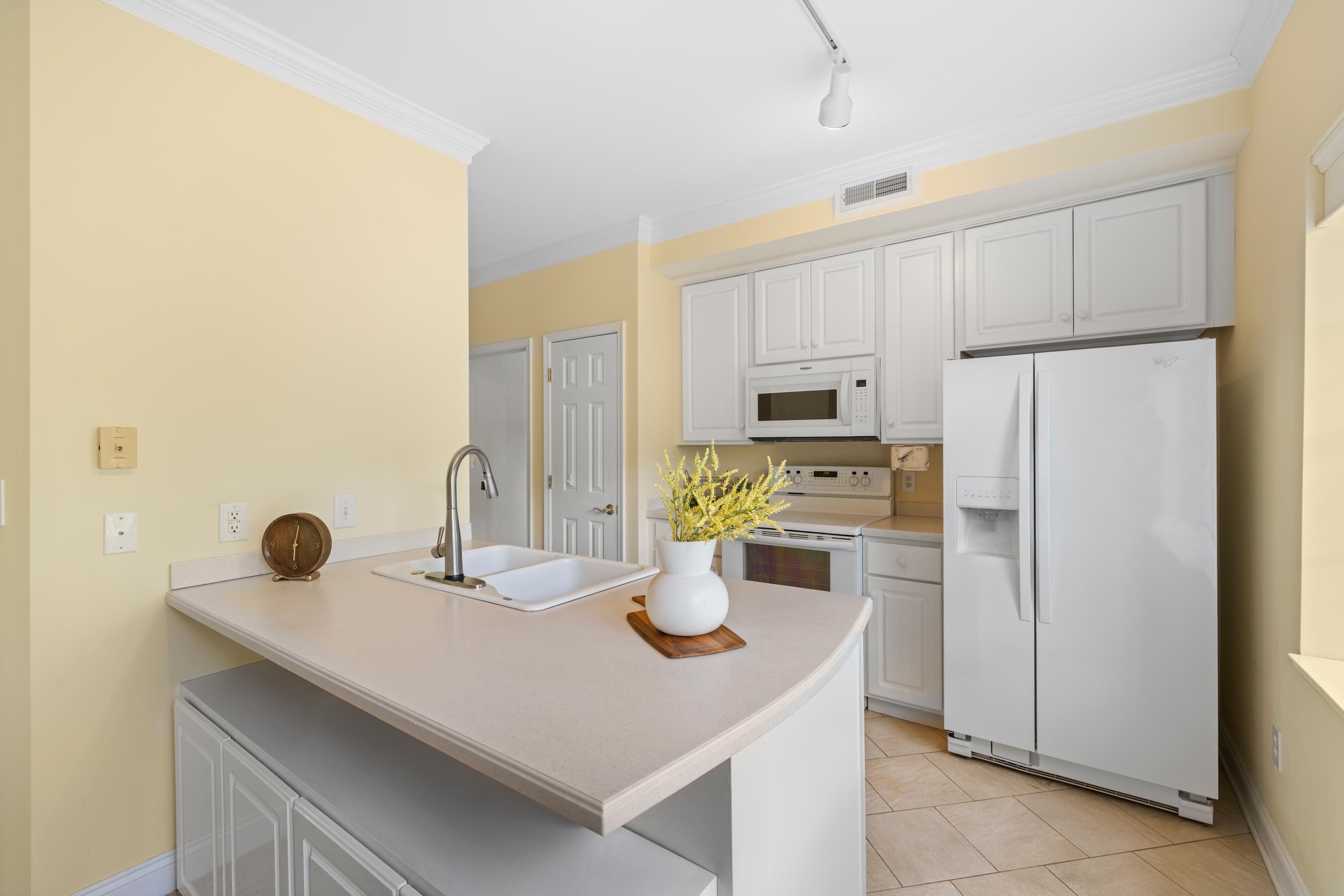 1410 North Coalter Street, Unit 202 Staunton, VA 24401 - Photo 20 of 52 a kitchen with a sink a refrigerator and white cabinets