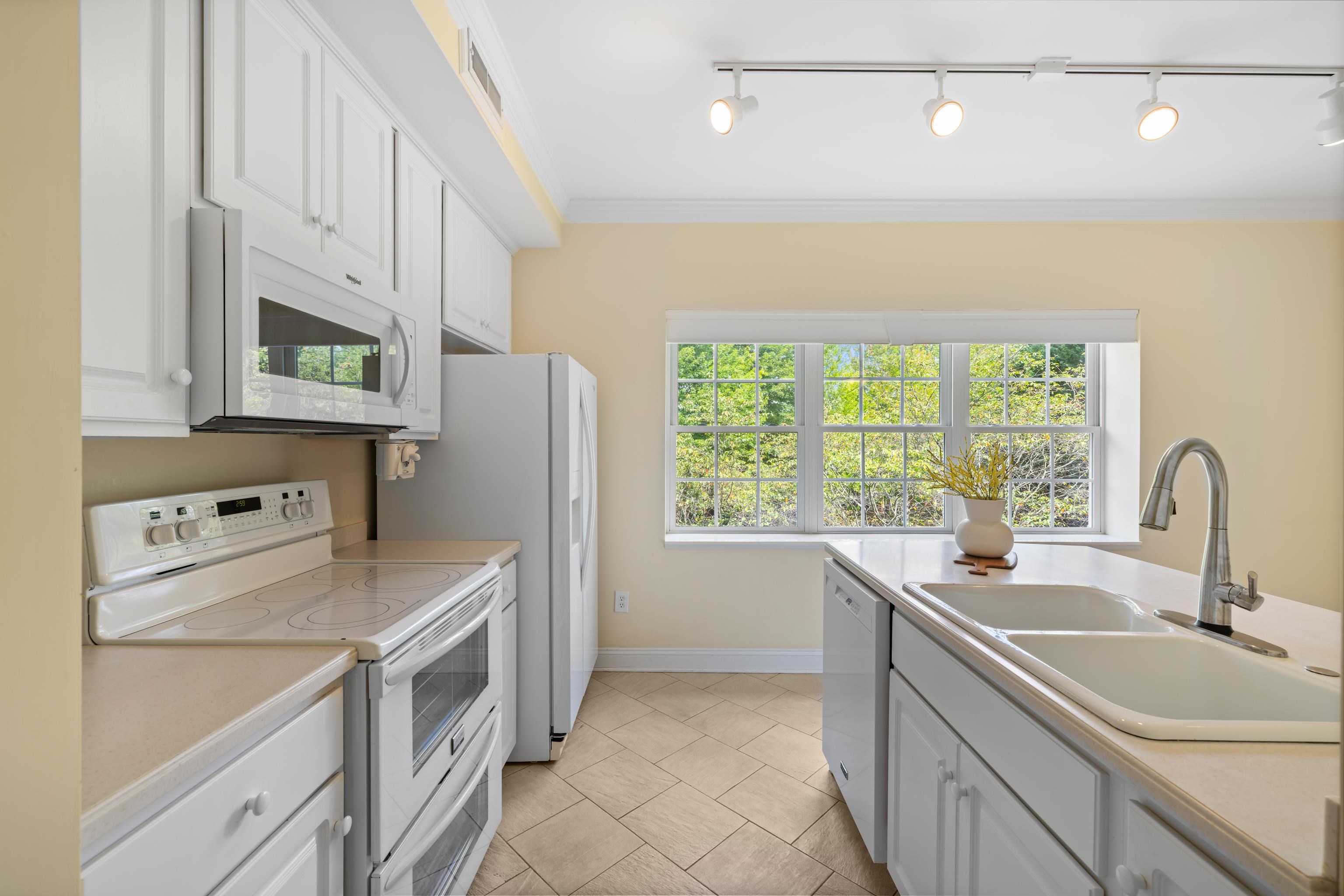 1410 North Coalter Street, Unit 202 Staunton, VA 24401 - Photo 26 of 52 a kitchen that has a sink cabinets appliances and a window