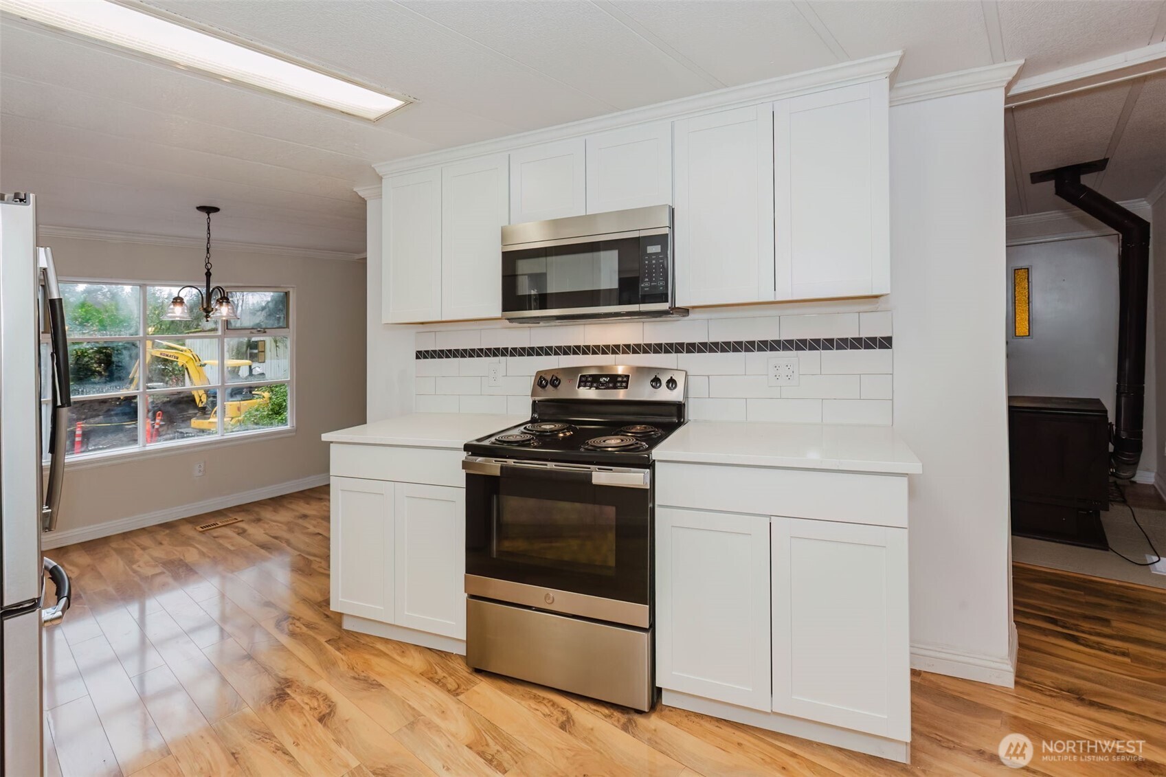 2535 70th Avenue Southwest, Unit 12 Tumwater, WA 98512 - Photo 12 of 33 a kitchen with stainless steel appliances a stove a microwave and sink