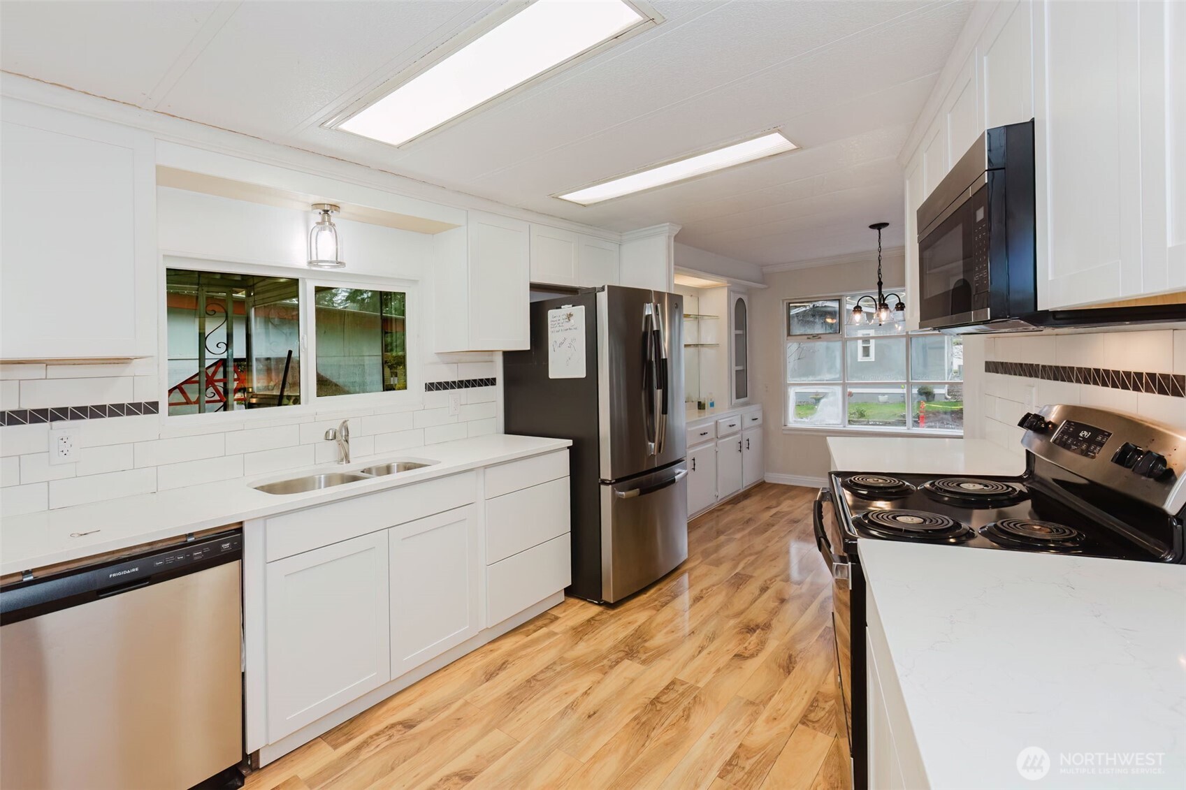 2535 70th Avenue Southwest, Unit 12 Tumwater, WA 98512 - Photo 13 of 33 a kitchen with a sink stainless steel appliances and cabinets