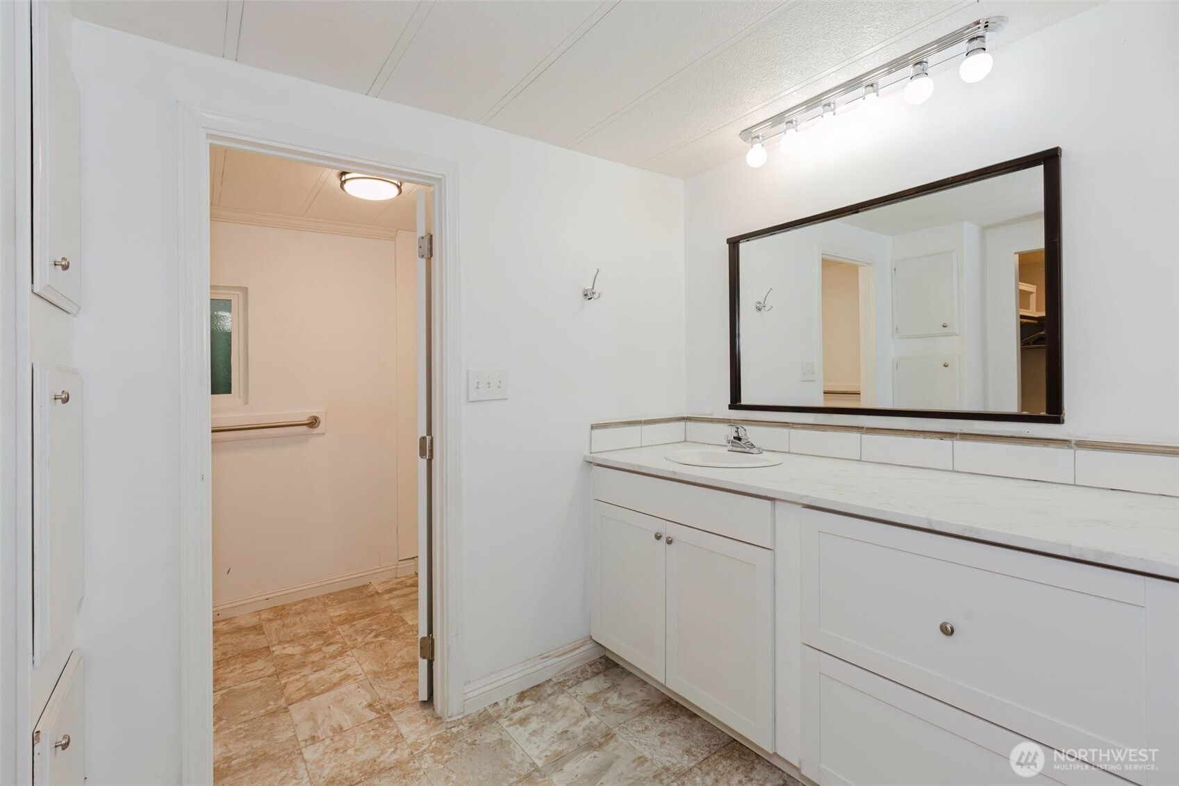 2535 70th Avenue Southwest, Unit 12 Tumwater, WA 98512 - Photo 16 of 33 a bathroom with a sink a vanity and a mirror