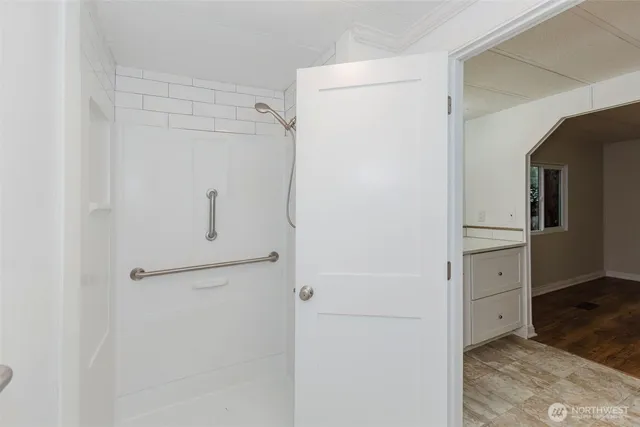 a view of a room with wooden floor and a window