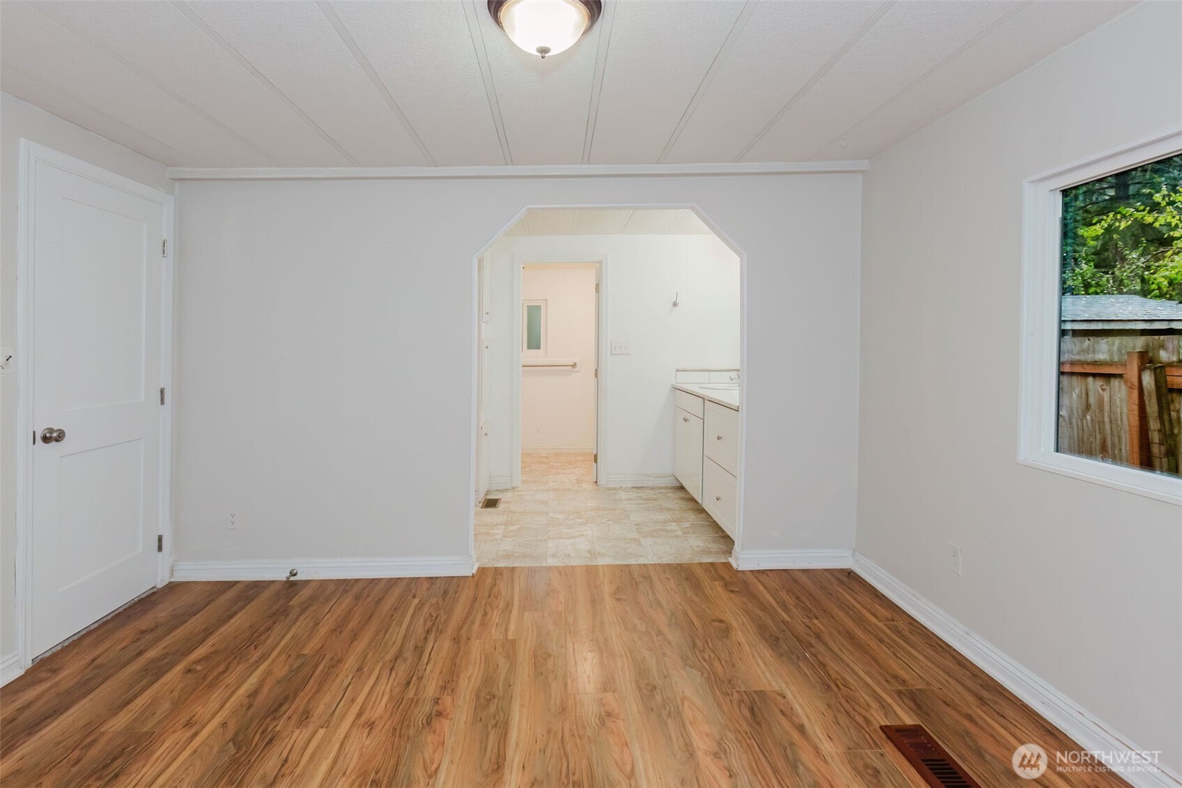 2535 70th Avenue Southwest, Unit 12 Tumwater, WA 98512 - Photo 19 of 33 a view of a room with wooden floor and a window
