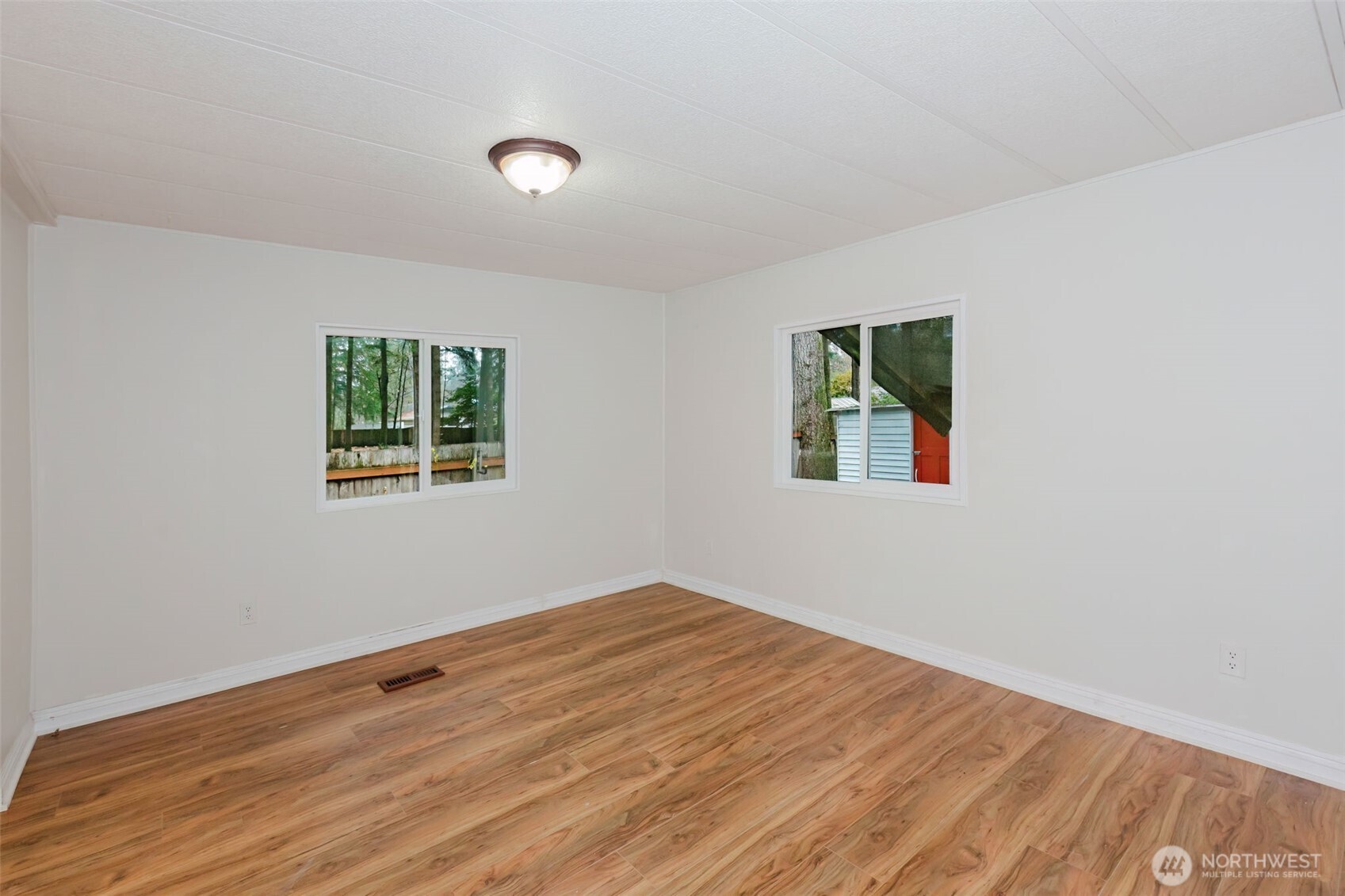 2535 70th Avenue Southwest, Unit 12 Tumwater, WA 98512 - Photo 23 of 33 a view of empty room with wooden floor and fan