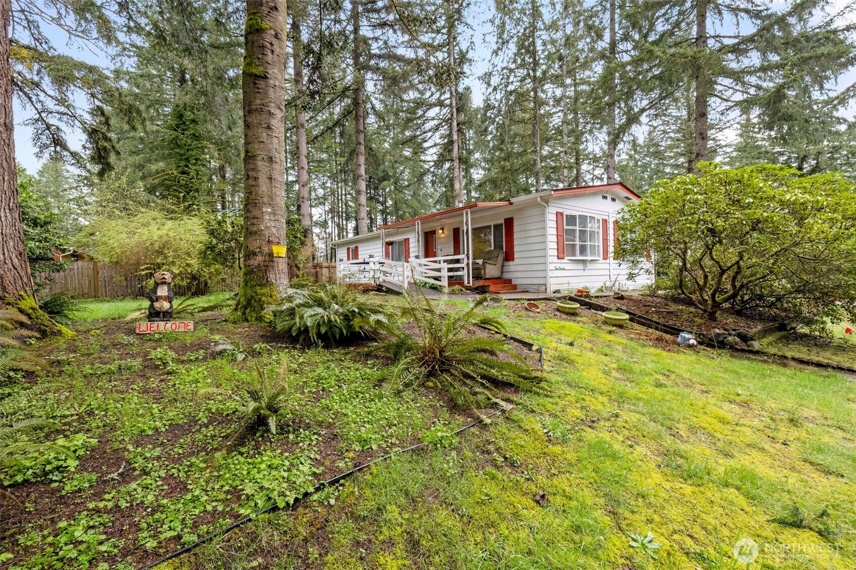 2535 70th Avenue Southwest, Unit 12 Tumwater, WA 98512 - Photo 33 of 33 a view of a house with a large tree and a yard