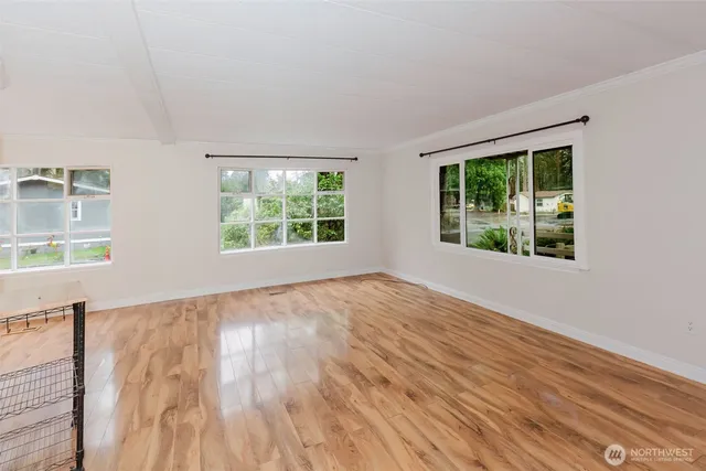 a view of a kitchen with wooden floor and a kitchen space