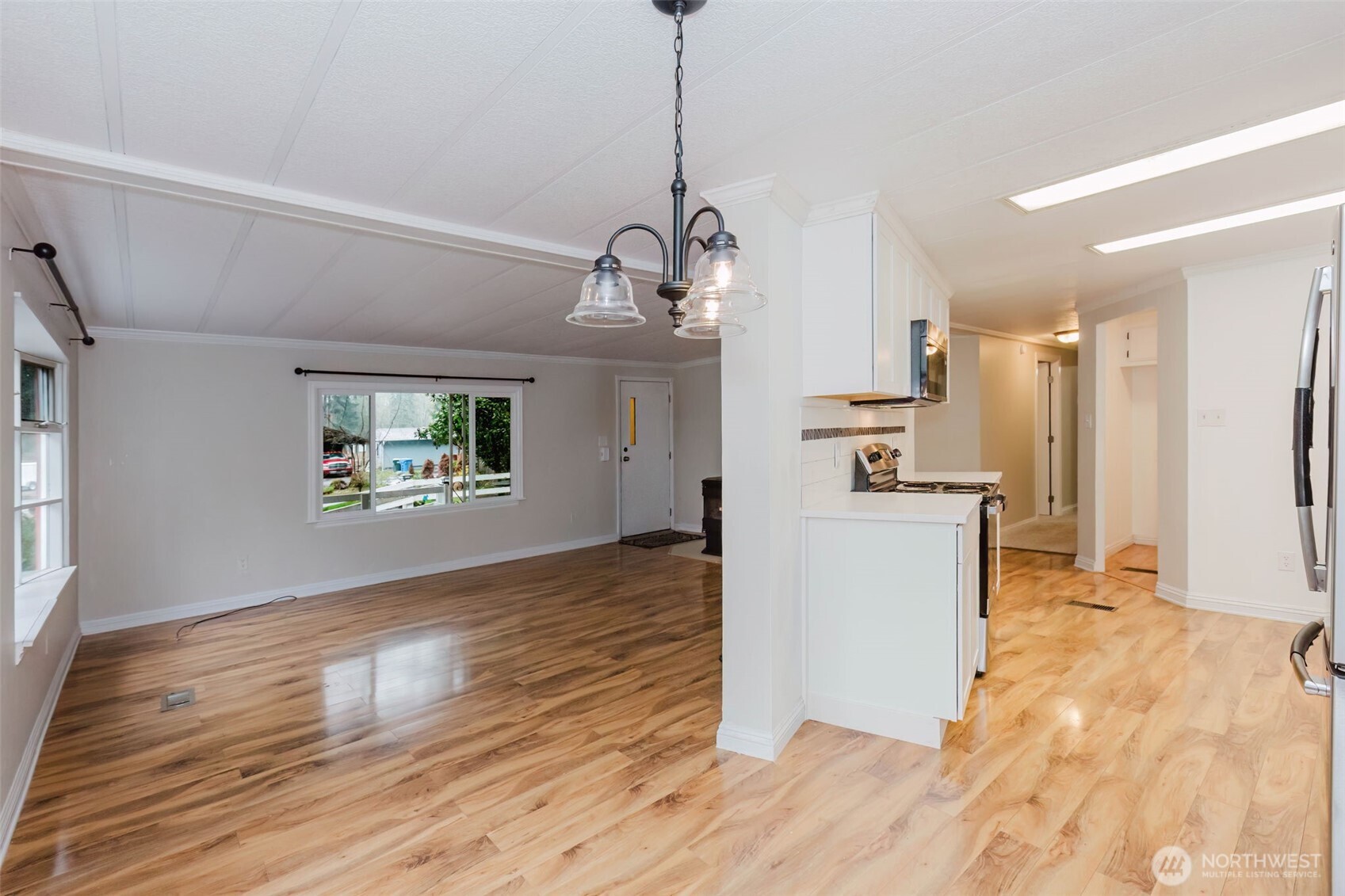2535 70th Avenue Southwest, Unit 12 Tumwater, WA 98512 - Photo 7 of 33 a view of a kitchen with wooden floor and a kitchen space