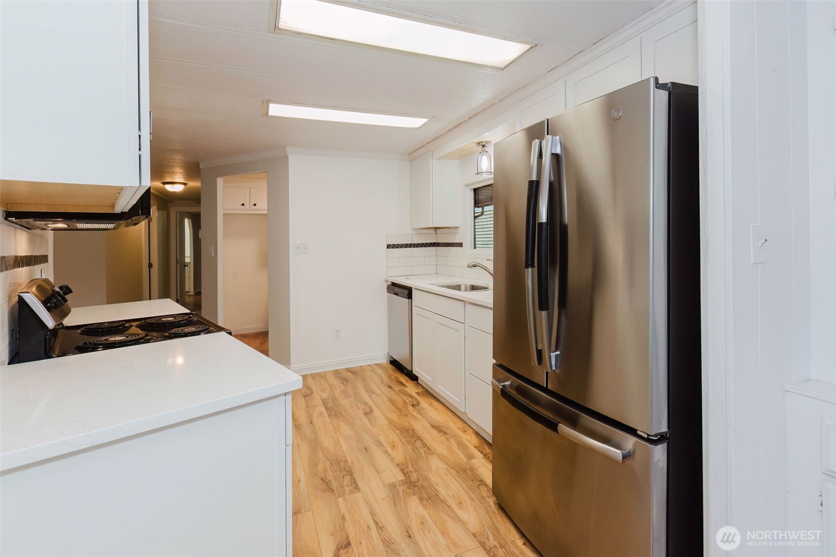 2535 70th Avenue Southwest, Unit 12 Tumwater, WA 98512 - Photo 9 of 33 a kitchen with stainless steel appliances a refrigerator stove and sink