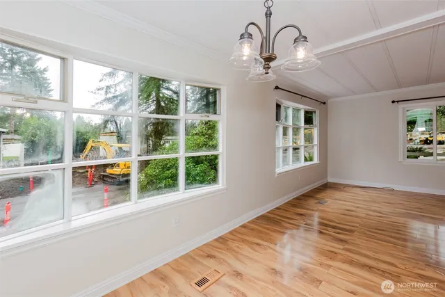 a view of an entryway with wooden floor and windows