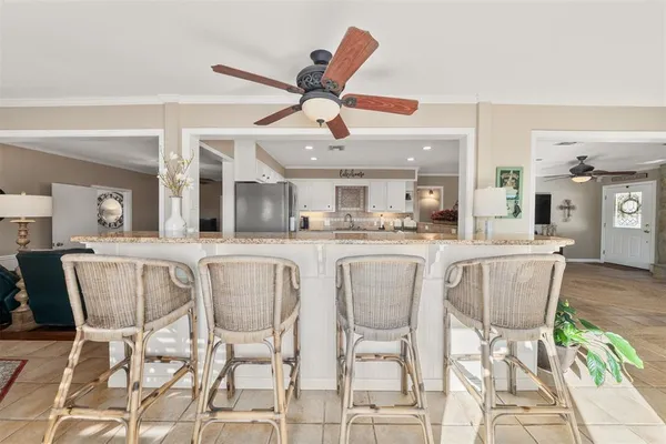 a dining room with furniture and a large window