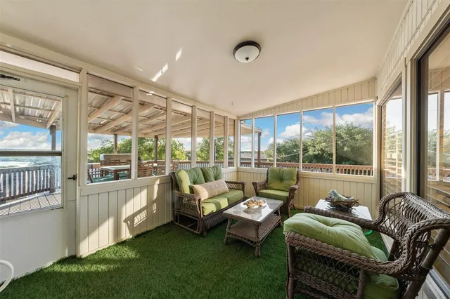a living room with furniture and a floor to ceiling window