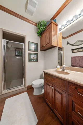 a spacious bathroom with a granite countertop sink a mirror and a toilet
