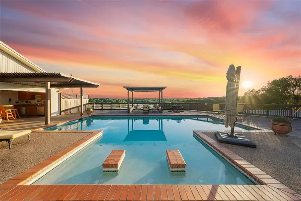 a view of swimming pool with a table and chairs