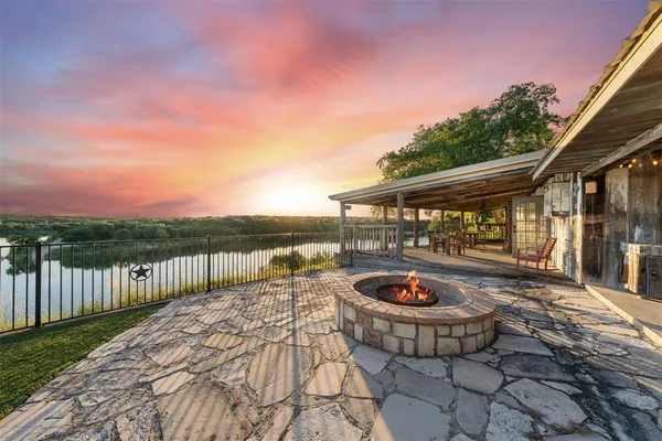 a backyard of a house with table and chairs