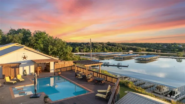an aerial view of a house with swimming pool and patio