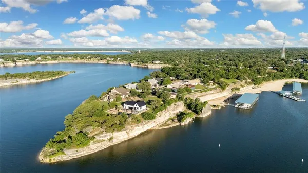 a view of a lake with lawn chairs