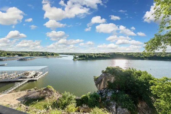 a view of a lake with houses in the back