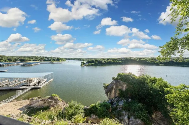 a view of a lake with houses in the back