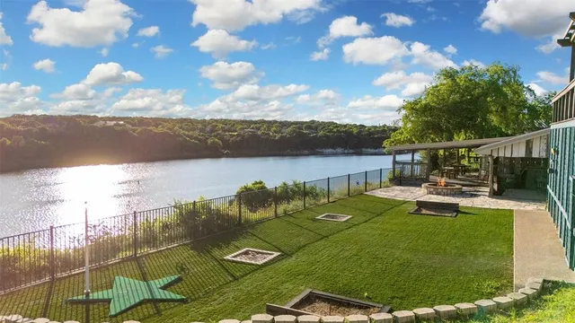 a view of a swimming pool with a patio and a yard