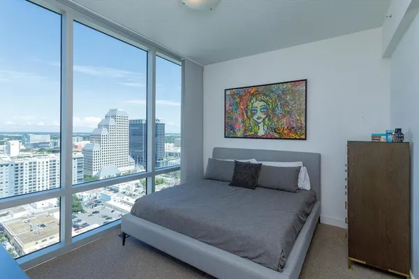 a bedroom with a large bed and a large window