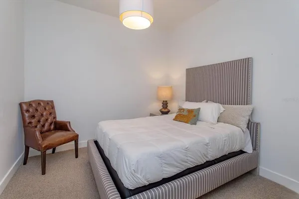 a bedroom with a bed and chair