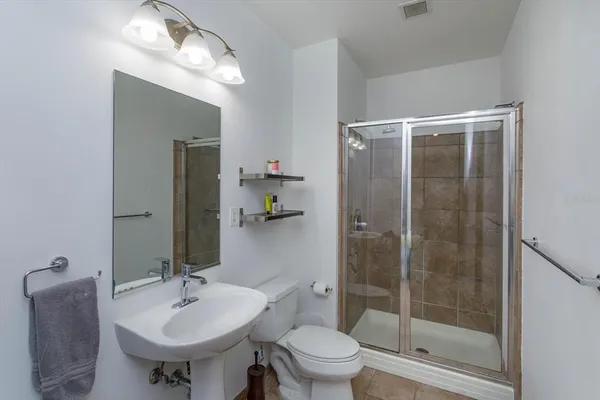 a bathroom with a sink toilet and shower