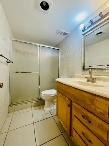 a view of a room with a white walls cabinets and a window