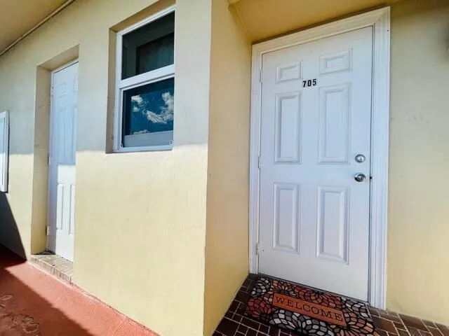 a view of an entryway with wooden floor