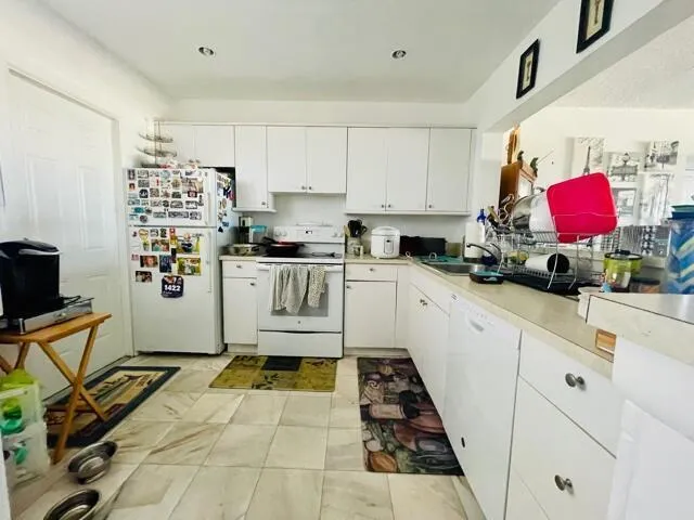 a kitchen with stainless steel appliances a stove a sink and a refrigerator