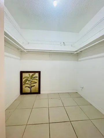 a bathroom with a sink a toilet a mirror and shower