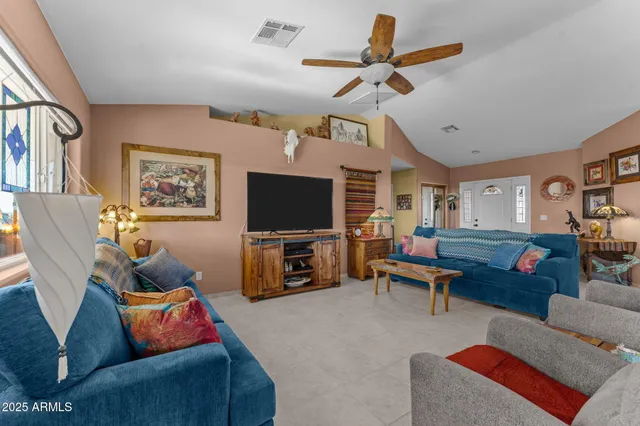a living room with furniture and a book shelf