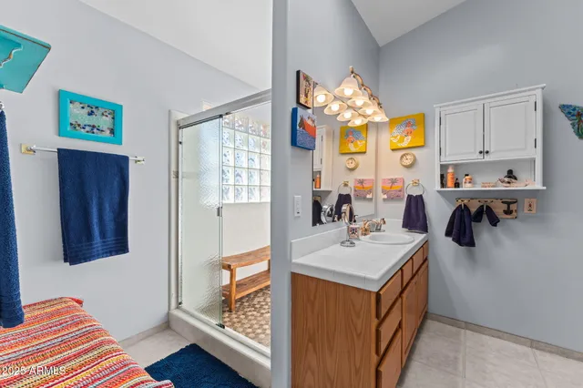 a bathroom with a window and a shower