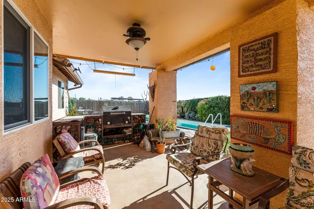 a view of a balcony with chairs and a potted plant