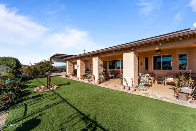 a view of an house with backyard porch and furniture
