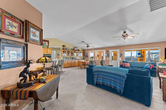 a living room with furniture a flat screen tv and a large window
