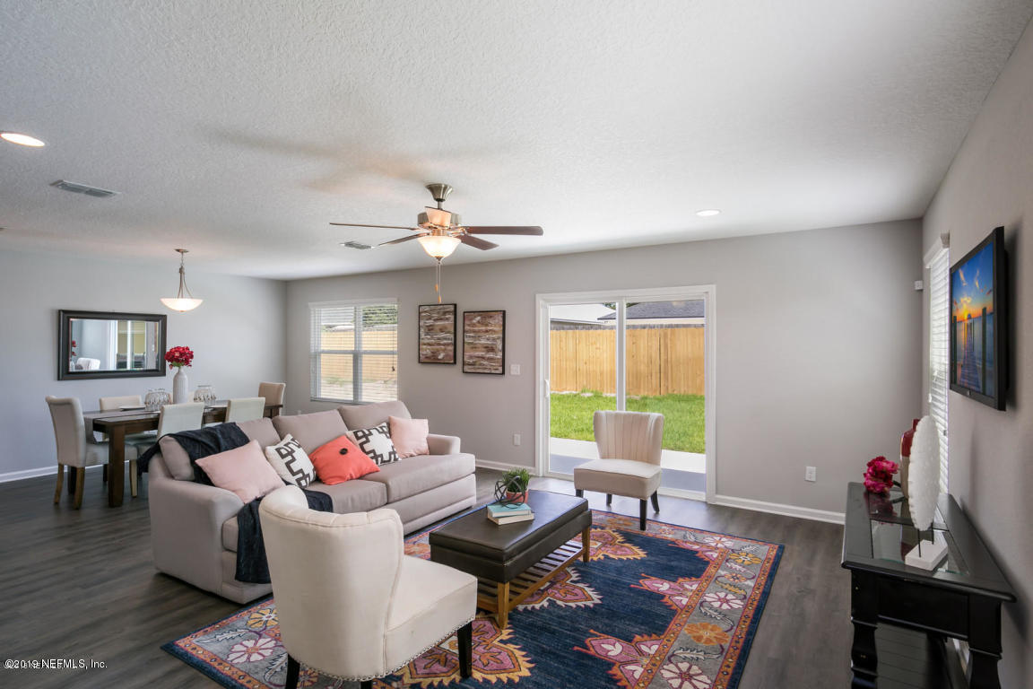 2247 Bayview Road Jacksonville, FL 32210 - Photo 4 of 11 a living room with furniture and a flat screen tv