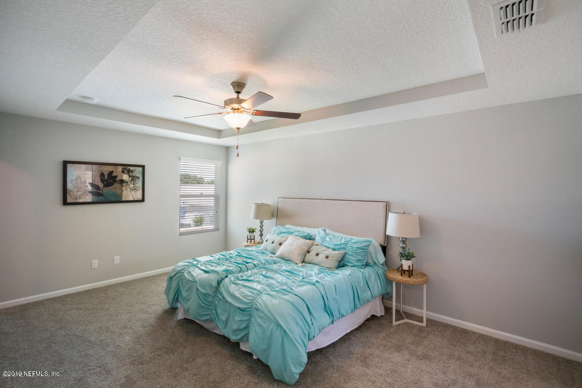 2247 Bayview Road Jacksonville, FL 32210 - Photo 6 of 11 a bedroom with a bed and a chandelier