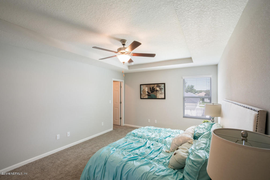 2247 Bayview Road Jacksonville, FL 32210 - Photo 7 of 11 a bedroom with a bed and a chandelier
