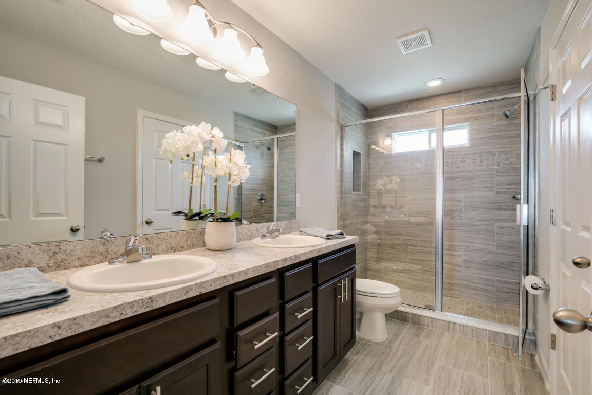 2247 Bayview Road Jacksonville, FL 32210 - Photo 8 of 11 a bathroom with a granite countertop sink a toilet a mirror and shower