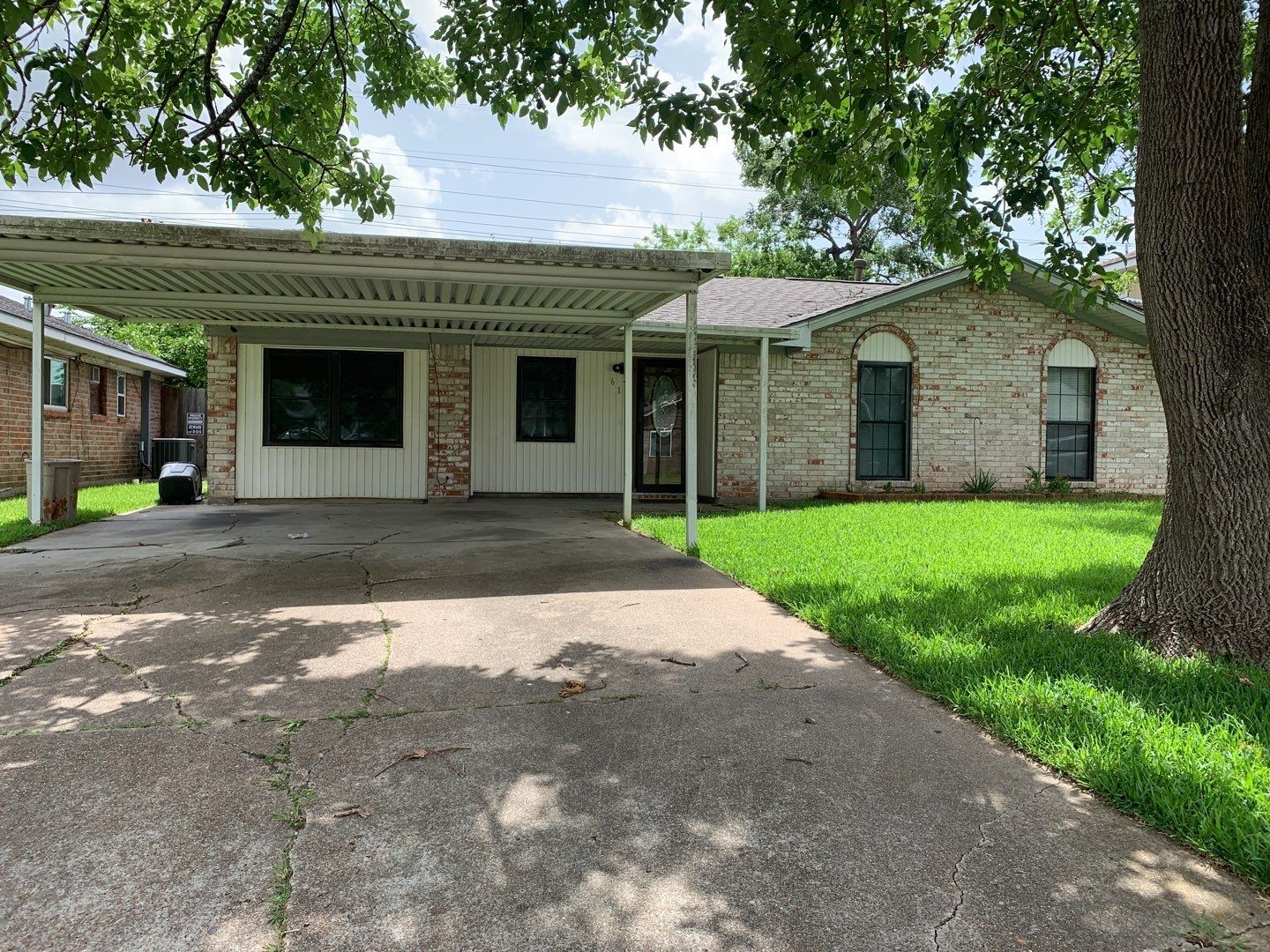 a front view of a house with yard and green space