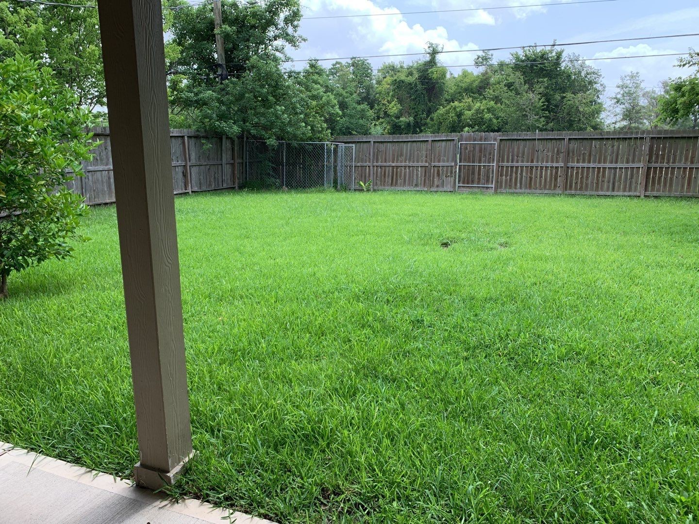 618 Overbluff Street Channelview, TX 77530 - Photo 27 of 32 a view of a backyard with a swing and wooden fence